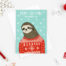 sloth christmas card featuring a sloth wearing a red christmas sweater with a blue background and snowflakes falling. Text above the sloth says 'Happy Christmas from an adorable sloth' Illustrative style.