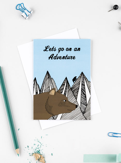Illustration of a bear in front of a mountain range with the text 'Lets go on an adventure'