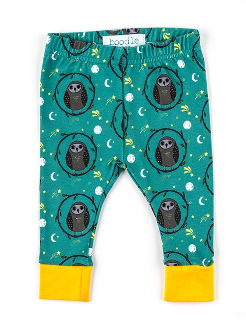photo of owl baby leggings featuring a repeat pattern of owls on a teal background with yellow cuffs
