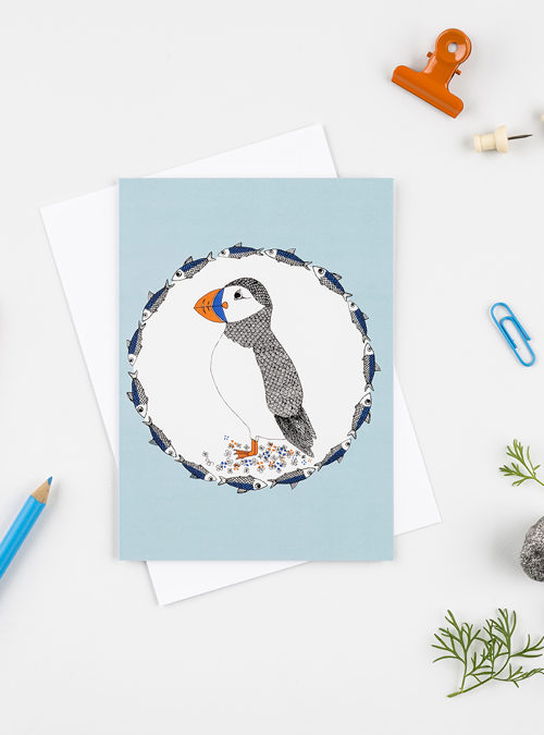 Puffin greetings card featuring an illustration of a puffin surrounded by herrings