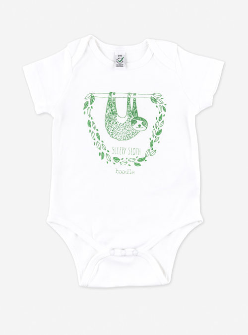 Organic cotton white babygrow featuring a hanging sloth surrounded by leaves with the text 'Sleepy sloth' underneath