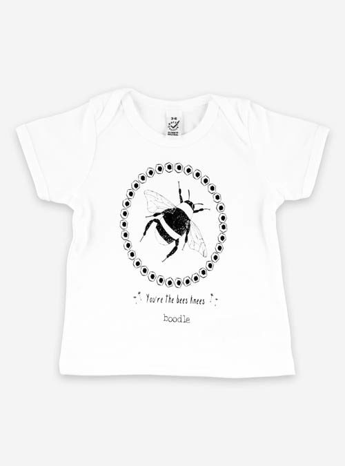 White organic cotto baby T-shirt with a black screen print of a bee surrounded by honeycomb with the caption 'You're the bees knees'